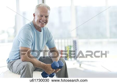 Senior man holding weights View Large Photo Image Stock Image - Senior man holding weights. Fotosearch