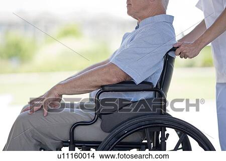 Picture - Senior man in wheelchair, side view. Fotosearch