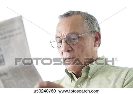 Stock Image - Senior man reading newspaper. Fotosearch