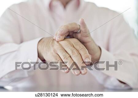 Picture - Senior man rubbing painful hand. Fotosearch