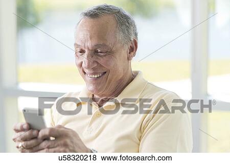 Senior man using cell phone View Large Photo Image Stock Photo - Senior man using cell phone. Fotosearch