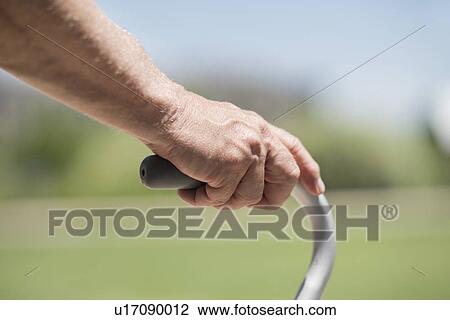 Stock Image - Senior man using walking frame, close up. Fotosearch