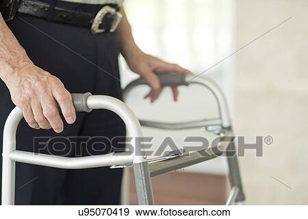 Senior man using walking support frame View Large Photo Image Stock Photo - Senior man using walking support frame. Fotosearch