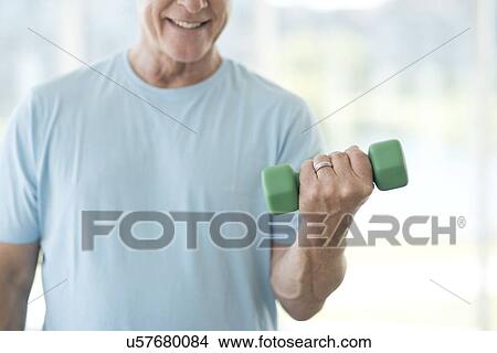Picture - Senior man using weights. Fotosearch