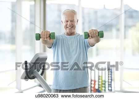 Stock Image - Senior man using weights. Fotosearch