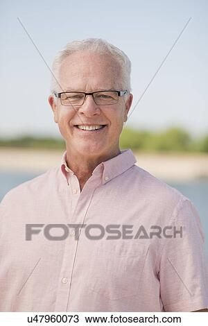 Stock Image - Senior man wearing glasses outdoors. Fotosearch