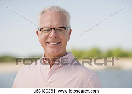 Senior man wearing glasses outdoors View Large Photo Image Stock Image - Senior man wearing glasses outdoors. Fotosearch