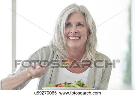 Senior woman eating salad View Large Photo Image Stock Photography - Senior woman eating salad. Fotosearch