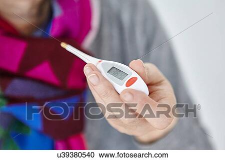 Senior woman holding digital thermometer, close-up View Large Photo Image Stock Image - Senior woman holding digital thermometer, close-up. Fotosearch
