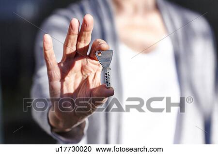 Senior woman holding security key, mid section View Large Photo Image Stock Image - Senior woman holding security key, mid section. Fotosearch