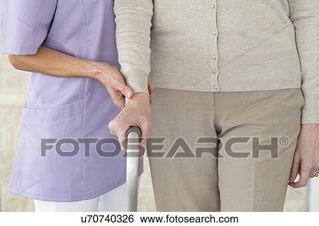 Senior woman holding support frame View Large Photo Image Stock Photograph - Senior woman holding support frame. Fotosearch