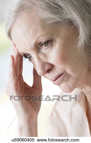 Stock Photography - Senior woman touching face. Fotosearch