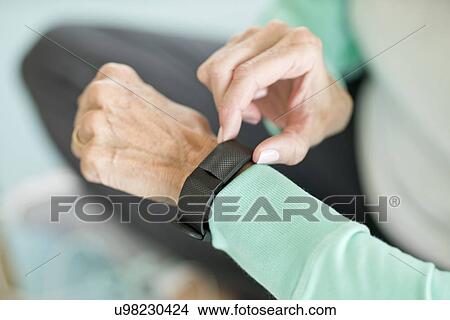 Senior woman using fitness tracker on wrist View Large Photo Image Picture - Senior woman using fitness tracker on wrist. Fotosearch