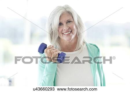 Senior woman using weights View Large Photo Image Stock Image - Senior woman using weights. Fotosearch