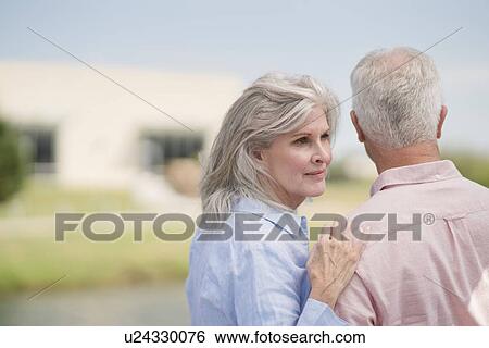 Senior woman with hand on man's shoulder View Large Photo Image Stock Photograph - Senior woman with hand on man's shoulder. Fotosearch