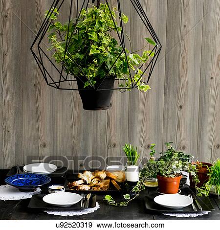 Stock Photo - Set kitchen table with bread slices, fresh herbs and spring onions. Fotosearch