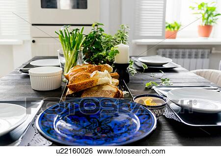 Set kitchen table with bread slices, fresh herbs and spring onions View Large Photo Image Stock Photograph - Set kitchen table with bread slices, fresh herbs and spring onions. Fotosearch