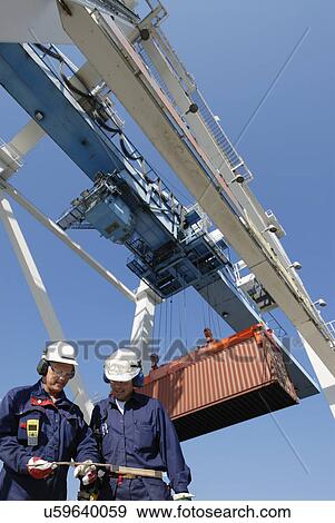 Shipping workers with cargo container View Large Photo Image Stock Photo - Shipping workers with cargo container. Fotosearch