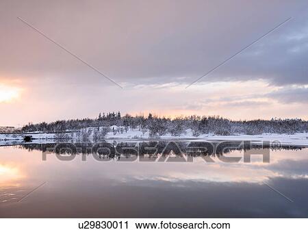Stock Image - Snow covered landscape view at Lake Ellidavatn, Iceland. Fotosearch