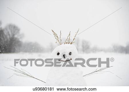 Stock Image - Snowman in snow-covered field. Fotosearch