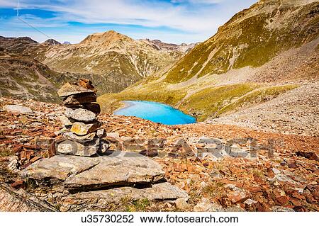 Stack of rocks, elevated view of lake in mountains View Large Photo Image Stock Image - Stack of rocks, elevated view of lake in mountains. Fotosearch