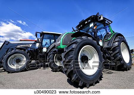 Stock Image - Stationary tractor with large tyres. Fotosearch