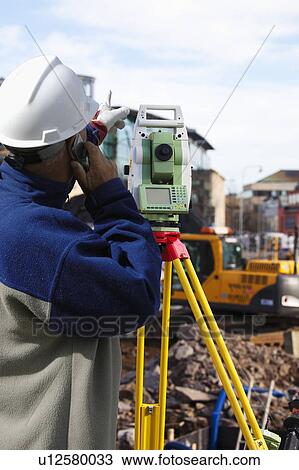 Surveyor using theodolite on construction site View Large Photo Image Stock Image - Surveyor using theodolite on construction site. Fotosearch