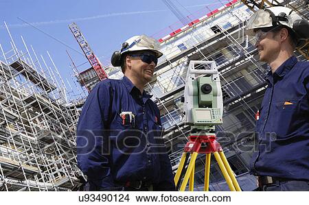 Picture - Surveyors using theodolite on site. Fotosearch