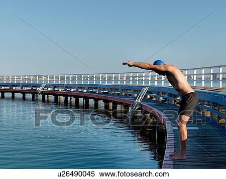 Stock Photography - Swimmer diving from boardwalk, Eastern Beach, Geelong, Victoria, Australia. Fotosearch