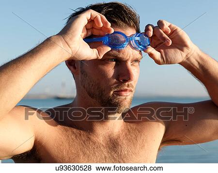 Swimmer putting on swimming goggles View Large Photo Image Stock Photo - Swimmer putting on swimming goggles. Fotosearch