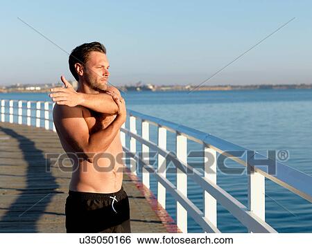 Swimmer stretching on boardwalk, Eastern Beach, Geelong, Victoria, Australia View Large Photo Image Stock Photograph - Swimmer stretching on boardwalk, Eastern Beach, Geelong, Victoria, Australia. Fotosearch