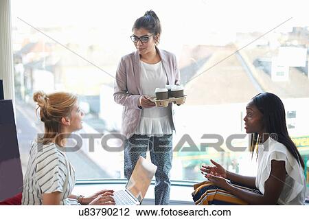 Three businesswomen having discussion View Large Photo Image Stock Image - Three businesswomen having discussion. Fotosearch