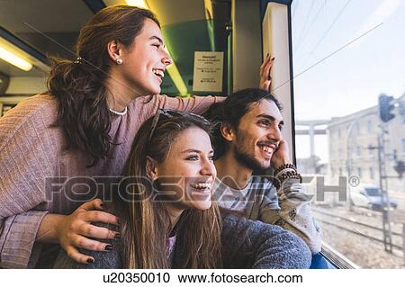 Three friends, on train, looking out of window at view, Lisbon, Portugal View Large Photo Image Stock Image - Three friends, on train, looking out of window at view, Lisbon, Portugal. Fotosearch