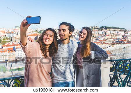 Three friends, outdoors, taking selfie with smartphone, Lisbon, Portugal View Large Photo Image Stock Image - Three friends, outdoors, taking selfie with smartphone, Lisbon, Portugal. Fotosearch