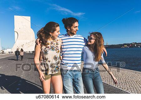 Three friends, walking by sea, Monument to the Discoveries in background, Lisbon, Portugal View Large Photo Image Picture - Three friends, walking by sea, Monument to the Discoveries in background, Lisbon, Portugal. Fotosearch