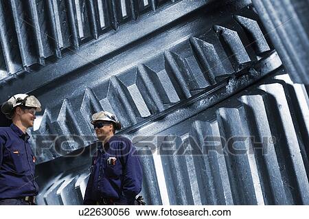 Two engineers and metal cogs View Large Photo Image Stock Photograph - Two engineers and metal cogs. Fotosearch