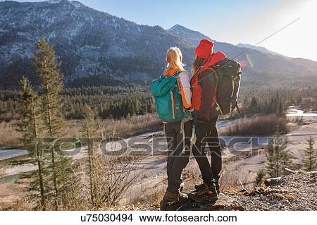 Picture - Two female hikers looking out at Bavarian Alps. Fotosearch
