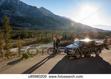 Two female hikers looking out at sunlit Bavarian Alps View Large Photo Image Stock Photo - Two female hikers looking out at sunlit Bavarian Alps. Fotosearch
