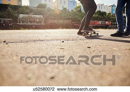 Two friends skateboarding, low section, Bristol, UK View Large Photo Image Stock Image - Two friends skateboarding, low section, Bristol, UK. Fotosearch