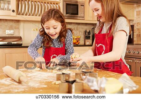 Two girls making star shape pastry at kitchen table View Large Photo Image Stock Photograph - Two girls making star shape pastry at kitchen table. Fotosearch