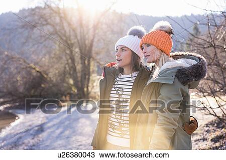 Stock Image - Two women looking out from lakeside in Bavarian Alps. Fotosearch