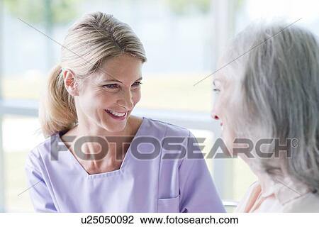 Two women smiling View Large Photo Image Stock Image - Two women smiling. Fotosearch