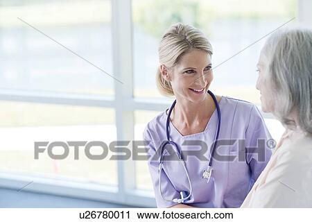 Two women smiling View Large Photo Image Stock Image - Two women smiling. Fotosearch