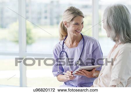 Two women smiling View Large Photo Image Stock Image - Two women smiling. Fotosearch