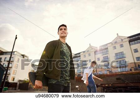 Stock Photo - Two young men skateboarding in urban area, Bristol, UK. Fotosearch