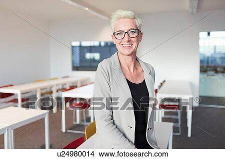 Picture - University lecturer in empty class. Fotosearch