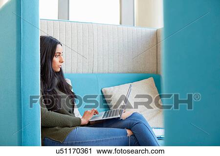 University student using laptop in modern cubicle View Large Photo Image Stock Image - University student using laptop in modern cubicle. Fotosearch