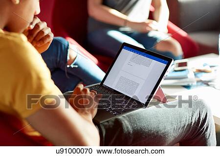 University student using laptop, relaxing with student friends View Large Photo Image Stock Image - University student using laptop, relaxing with student friends. Fotosearch