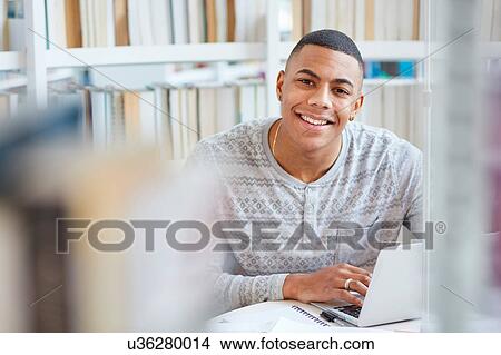 University student working in library View Large Photo Image Picture - University student working in library. Fotosearch