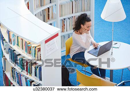 University student working in library View Large Photo Image Stock Photo - University student working in library. Fotosearch